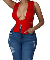 Woman wearing a red deep V-neck sleeveless knit crop top with a wrapped waist design, styled with distressed high-waisted blue jeans.