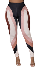 Woman wearing high-waisted leggings with a multicolor wave-pattern design in shades of black, blush, brown, and cream.