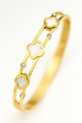 Gold bracelet with clover-shaped links on a white background