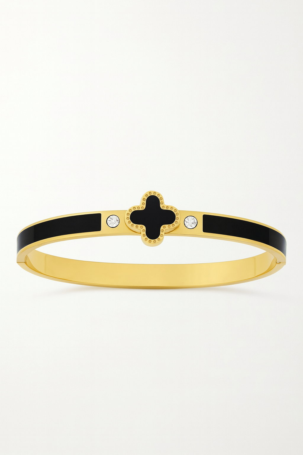 Gold bracelet with black clover design on a white background