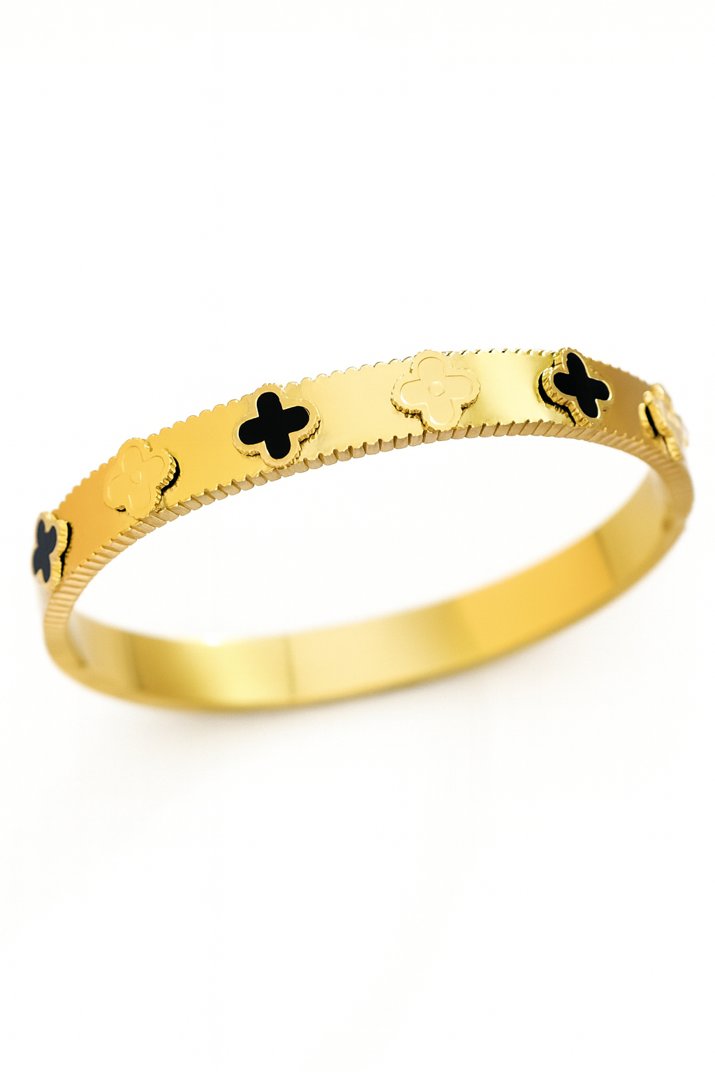 Gold bracelet with black clover designs on a white background