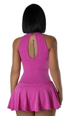 Back view of a woman in a ribbed hot pink halter mini dress featuring a rounded keyhole back cutout and flowy skater-style hem.