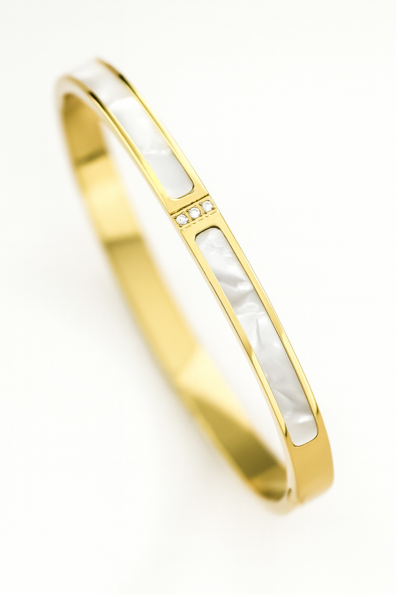 Gold and white bangle on a white background
