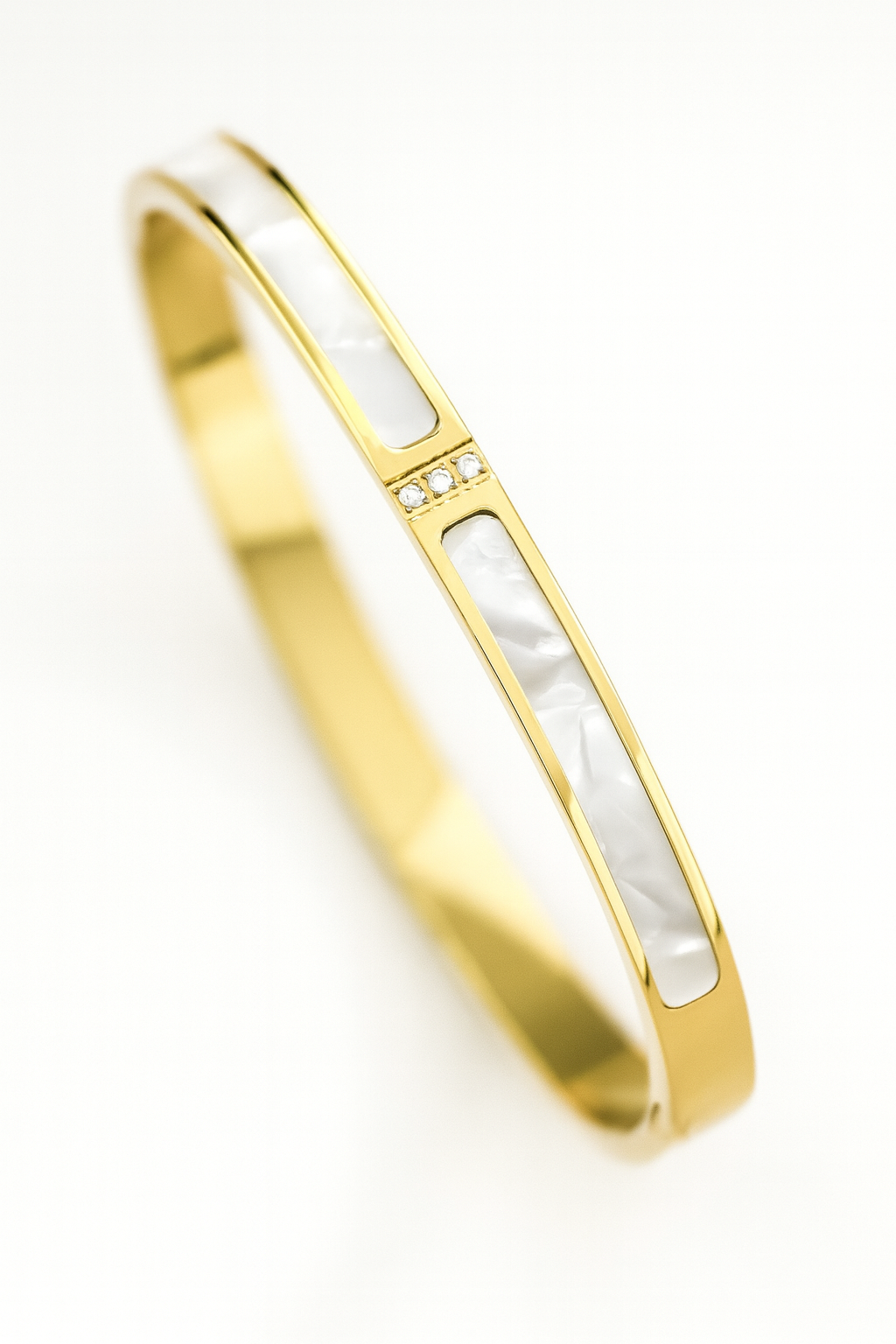Gold and white bangle on a white background