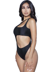 Woman wearing a black one-shoulder cut-out monokini swimsuit featuring an asymmetrical neckline and front midriff cut-out.