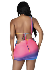 Woman wearing a vibrant ombré two-piece bikini set with a halter triangle top and matching bodycon swim skirt featuring side cut-outs and adjustable tie details.